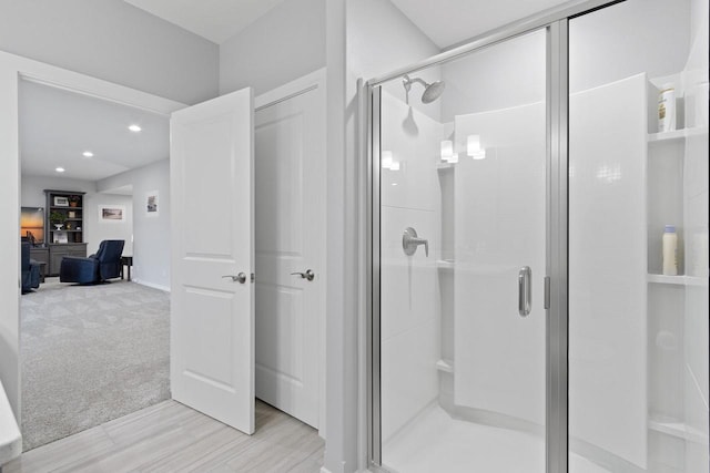 bathroom with a shower with door