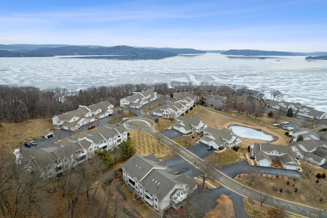 drone / aerial view with a water and mountain view