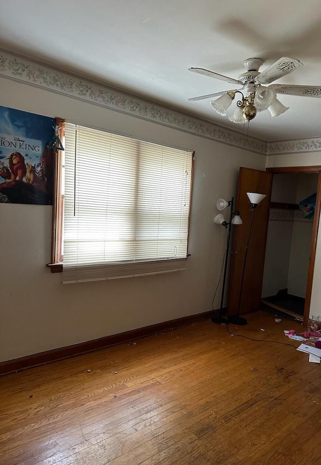 unfurnished bedroom with multiple windows, a closet, ceiling fan, and light hardwood / wood-style flooring