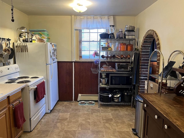 kitchen with wooden walls, baseboard heating, and white range with electric stovetop