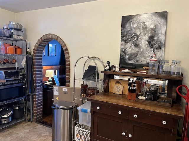 bar featuring wood counters and dark brown cabinets