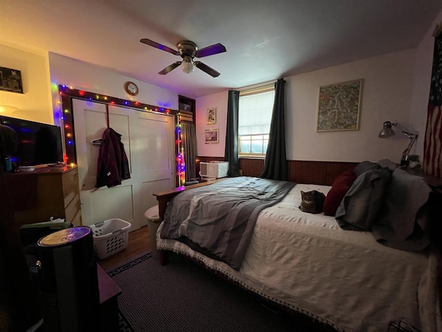 bedroom with hardwood / wood-style flooring, ceiling fan, and a closet