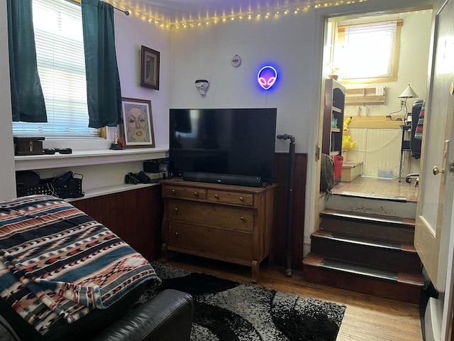 bedroom with ensuite bath and light wood-type flooring