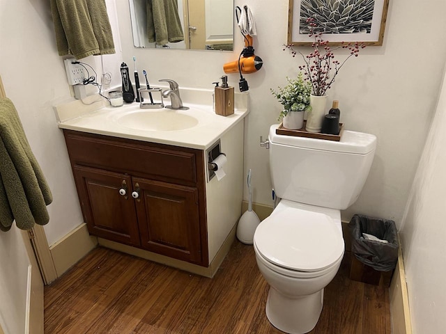 bathroom with vanity, wood-type flooring, and toilet