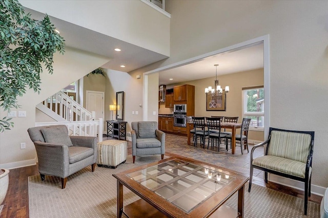 tiled living room featuring a chandelier and a high ceiling