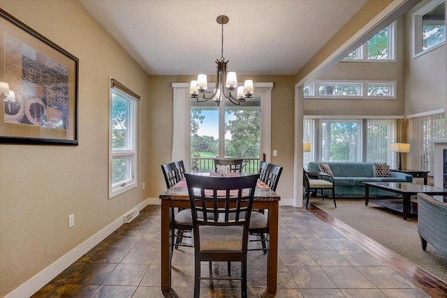 tiled dining room featuring a chandelier