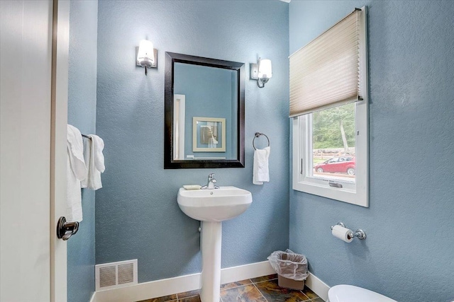 bathroom with tile flooring and toilet