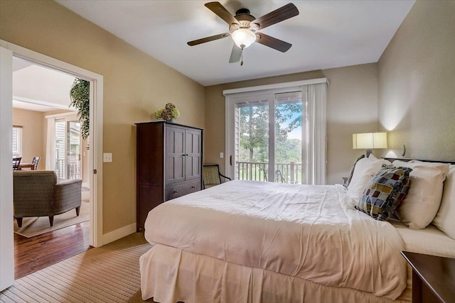 bedroom with ceiling fan, multiple windows, access to outside, and light hardwood / wood-style flooring