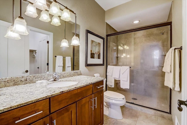 bathroom with oversized vanity, toilet, tile floors, and a shower with shower door