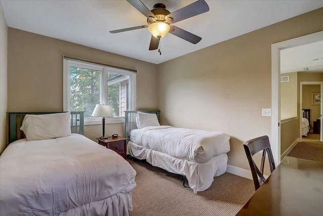 bedroom with ceiling fan and dark colored carpet