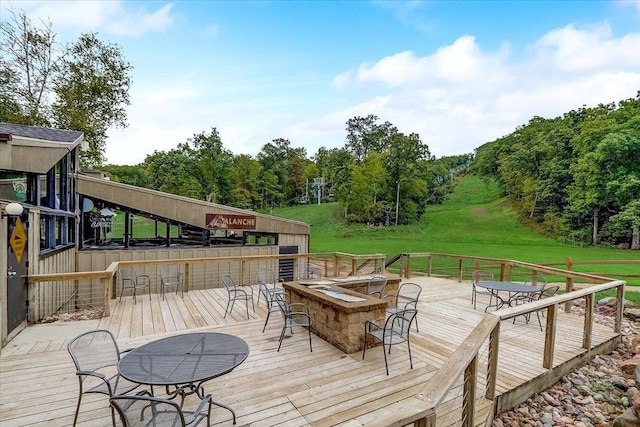 wooden deck featuring a lawn