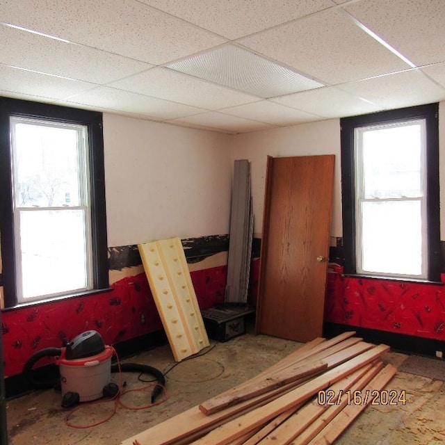 interior space featuring a paneled ceiling and multiple windows