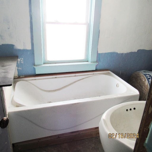 bathroom featuring a bath to relax in