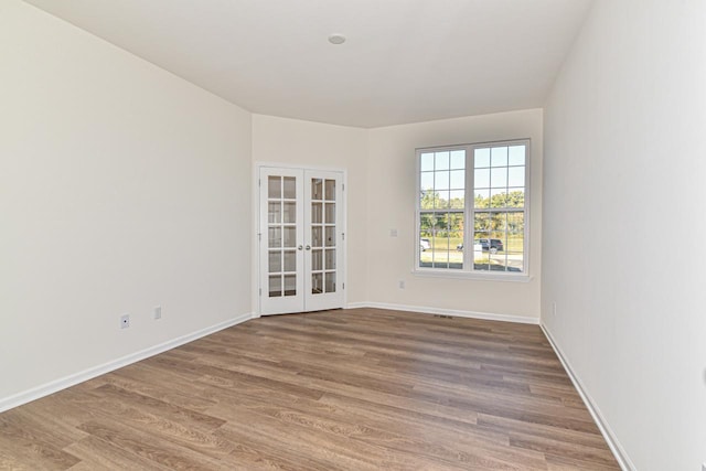 empty room featuring hardwood / wood-style floors and french doors