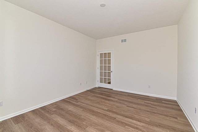 empty room with wood-type flooring