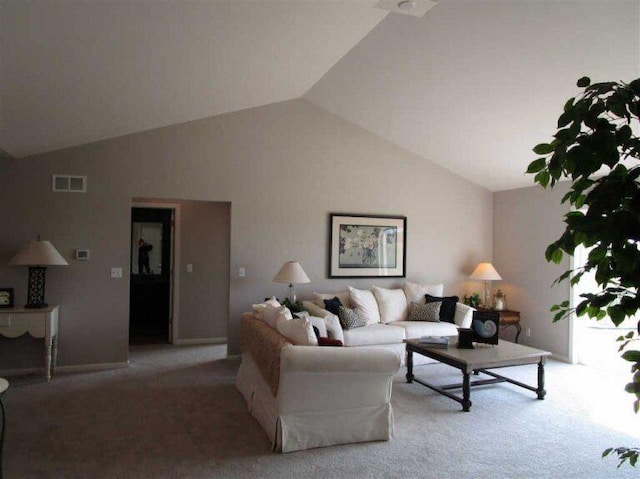 carpeted living room featuring lofted ceiling