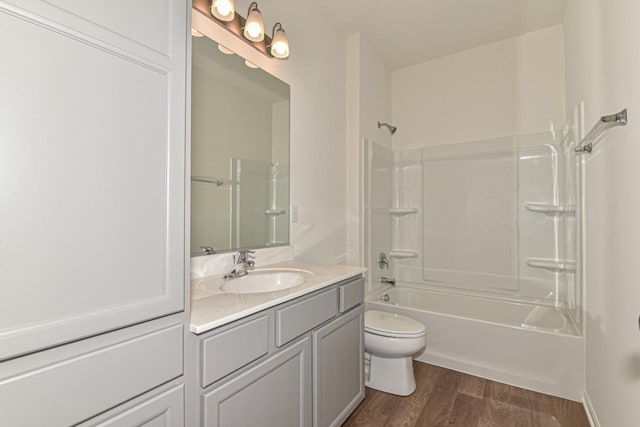 full bathroom featuring vanity, hardwood / wood-style floors, toilet, and bathing tub / shower combination