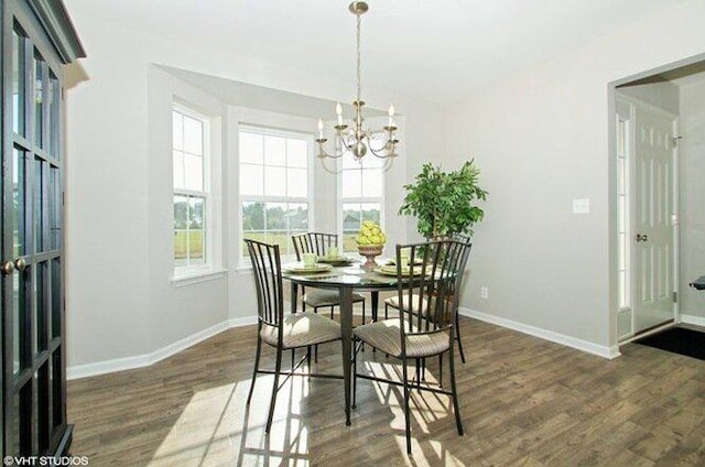 dining area with a chandelier and dark hardwood / wood-style flooring