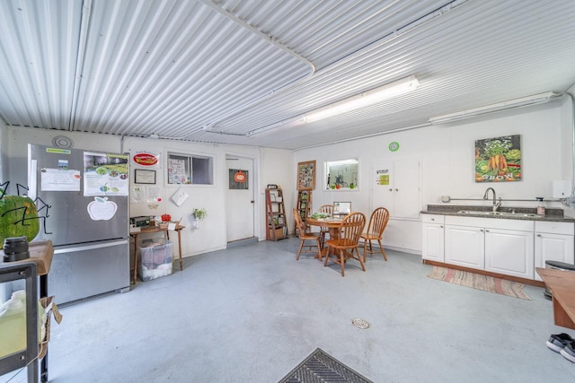 garage featuring stainless steel fridge and sink