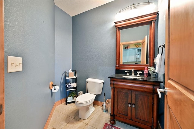 bathroom featuring toilet, tile floors, and vanity