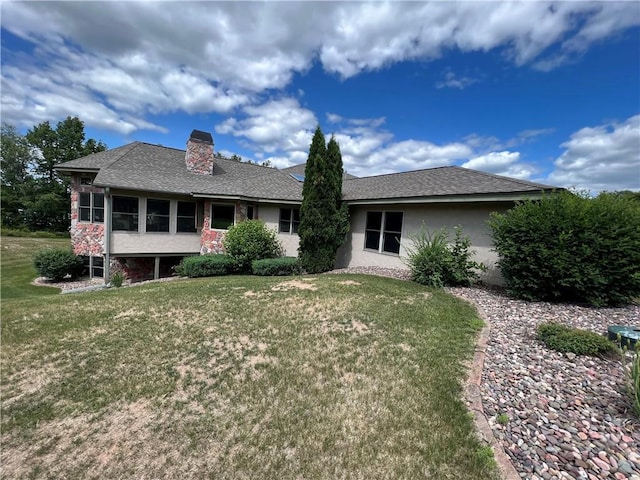 back of house with a lawn