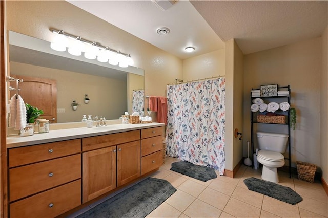 bathroom with toilet, tile floors, and vanity