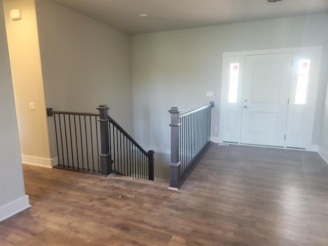 entryway with dark hardwood / wood-style flooring