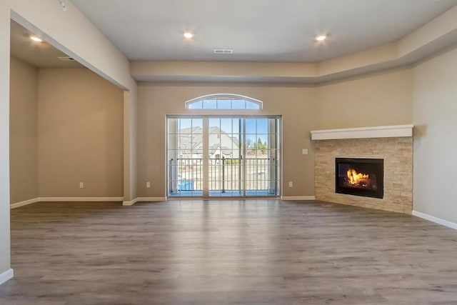 unfurnished living room featuring a fireplace and wood-type flooring