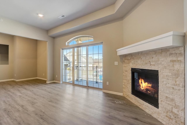 unfurnished living room featuring a fireplace and hardwood / wood-style flooring