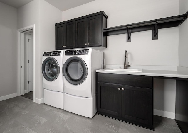 washroom with washing machine and dryer, sink, and cabinets