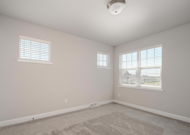 spare room with light colored carpet