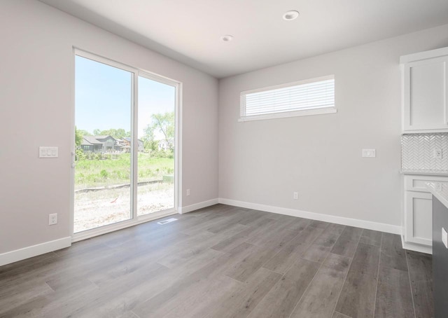 unfurnished living room featuring a healthy amount of sunlight and light wood-type flooring