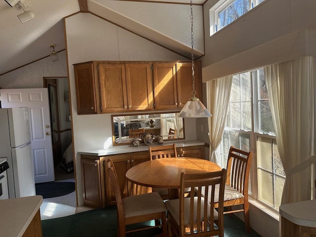 kitchen featuring high vaulted ceiling, light colored carpet, and white refrigerator