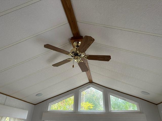 room details featuring ceiling fan and beamed ceiling