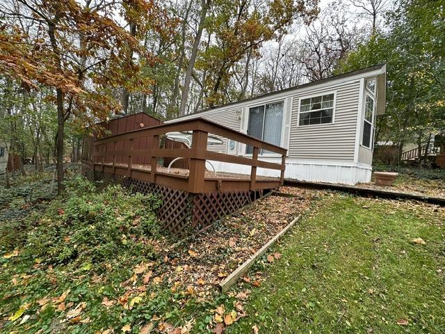 back of house featuring a deck and a yard