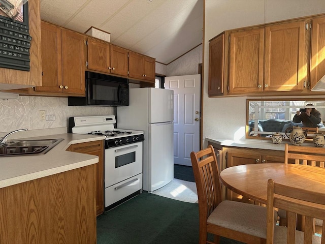 kitchen featuring sink, vaulted ceiling, carpet floors, and gas range gas stove