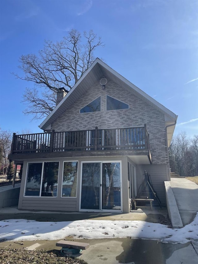 W1188 Spring Grove Rd, Green Lake, WI 54971 - snow covered rear of property featuring a balcony