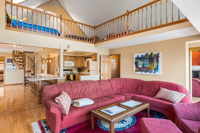 W1188 Spring Grove Rd, Green Lake, WI 54971 - living room featuring light parquet flooring and a towering ceiling