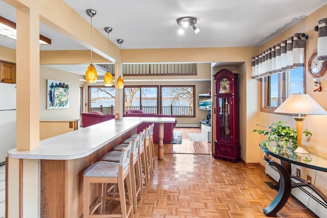 W1188 Spring Grove Rd, Green Lake, WI 54971 - kitchen with a kitchen bar, light parquet floors, and a wealth of natural light