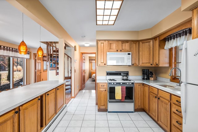 W1188 Spring Grove Rd, Green Lake, WI 54971 - kitchen featuring sink, white appliances, light tile floors, and decorative light fixtures