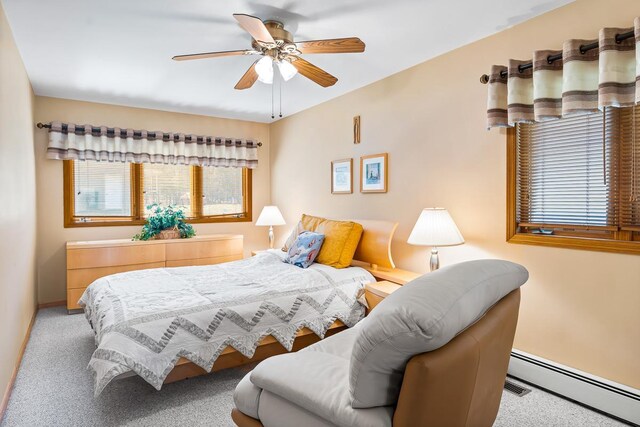 W1188 Spring Grove Rd, Green Lake, WI 54971 - bedroom with ceiling fan, light colored carpet, and a baseboard heating unit