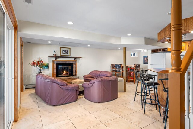 W1188 Spring Grove Rd, Green Lake, WI 54971 - living room featuring a baseboard radiator, a fireplace, and light tile floors