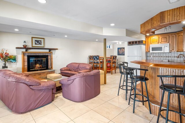 W1188 Spring Grove Rd, Green Lake, WI 54971 - tiled living room featuring a brick fireplace