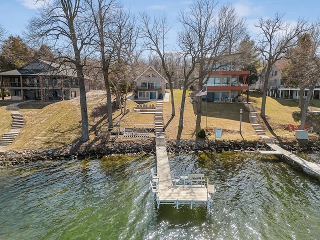 W1188 Spring Grove Rd, Green Lake, WI 54971 - dock area with a balcony, a water view, and a lawn