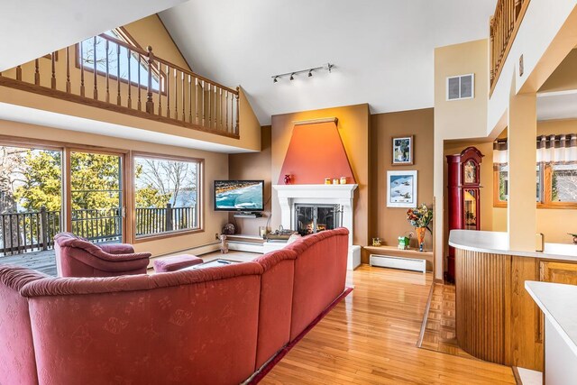 W1188 Spring Grove Rd, Green Lake, WI 54971 - living room with track lighting, light wood-type flooring, and high vaulted ceiling