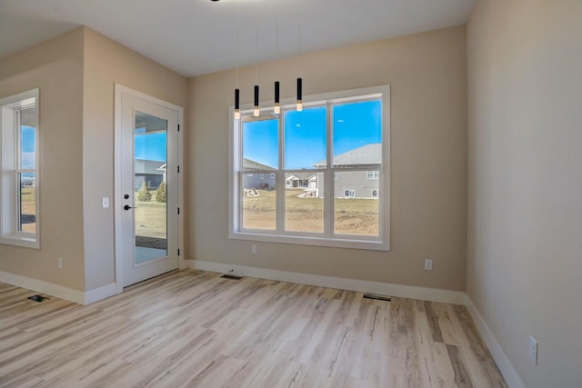 entryway with light hardwood / wood-style flooring and a wealth of natural light