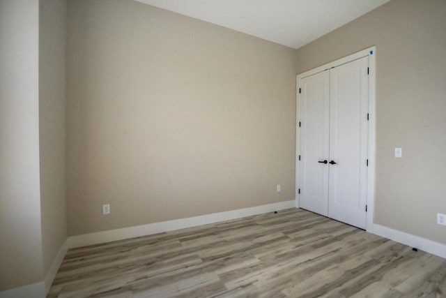 unfurnished bedroom with light wood-type flooring