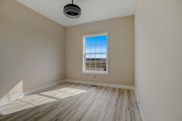 unfurnished room with light wood-type flooring