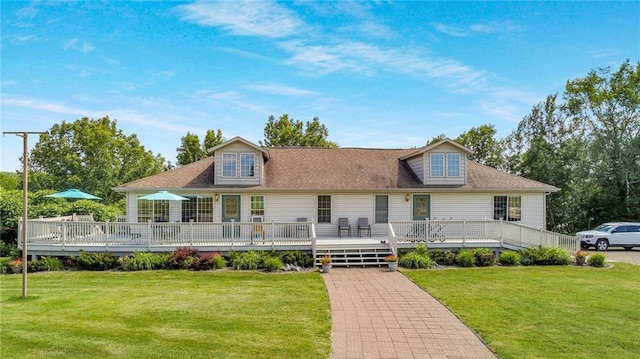 view of front facade with a deck and a front lawn