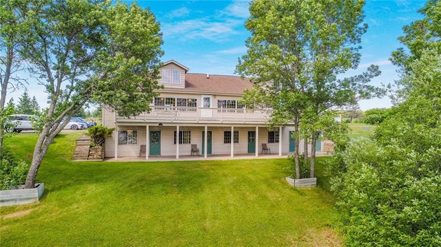 back of property with a yard, a deck, and a patio area